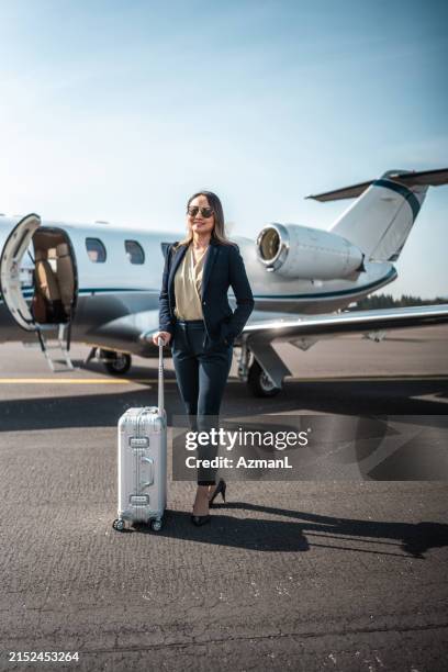 confident asian businesswoman leaving private aircraft - corporate jet stock pictures, royalty-free photos & images