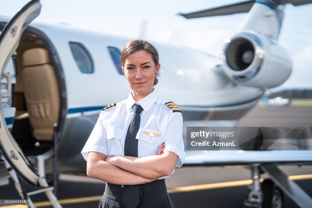 Confident Female Pilot by Private Jet