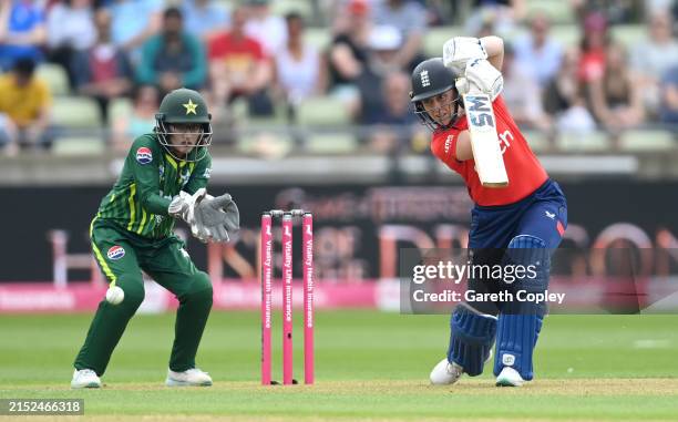 Heather Knight of England bats watched by Pakistan wicketkeeper Muneeba Ali during the 1st Women's Vitality IT20 match between England and Pakistan...