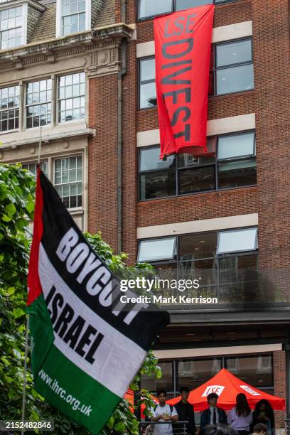 Palestinian flag bearing the words 'Boycott Israel' and a banner reading 'LSE Divest' are pictured during a press conference by students from the...