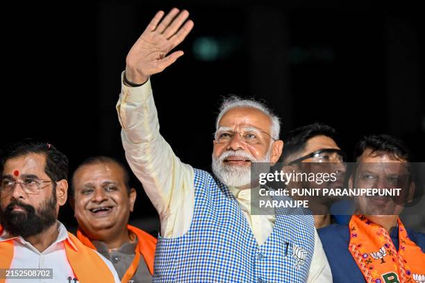 India's Prime Minister and leader of the ruling Bharatiya Janata Party Narendra Modi with chief minister of Maharashtra state Eknath Shinde and their...