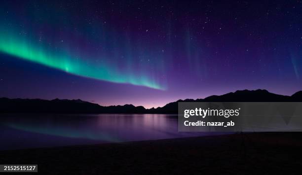 southern lights over lake te anau. - dramatic landscape stock pictures, royalty-free photos & images