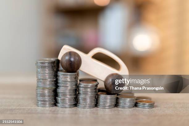 car model on money coins pile. finance and car loan - autokredit stock-fotos und bilder