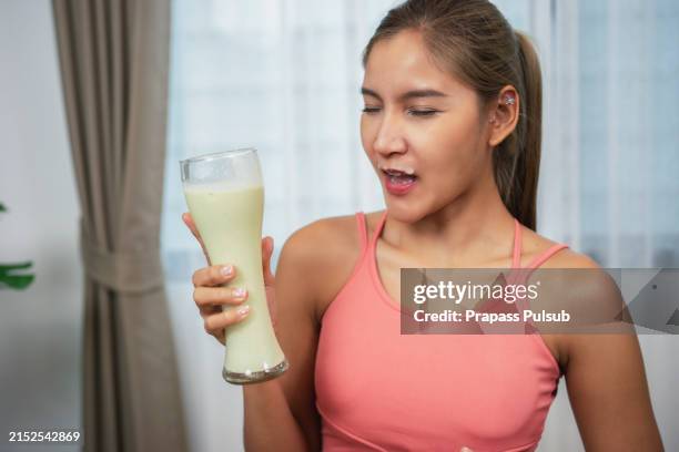 woman drinking glass of juice - pouring cranberry juice stock pictures, royalty-free photos & images