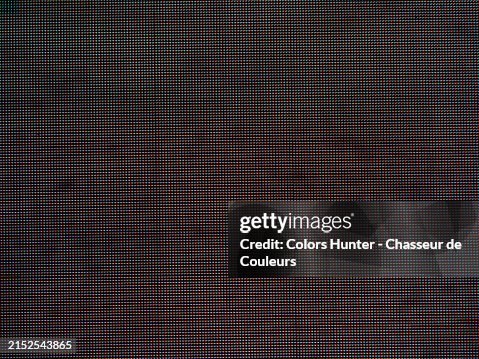 Red and blue bright LEDs on a black background. Close-up of an advertising screen in Times Squares, Manhattan, New York State, United States. Natural light and colors. Red and blue bright LEDs on a black background. Close-up of an advertising screen in Times Squares, Manhattan, New York State, United States. Natural light and colors.
