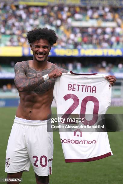 Valentino Lazaro of Torino FC poses for a photo with his shirt following the team's victory during the Serie A TIM match between Hellas Verona FC and...