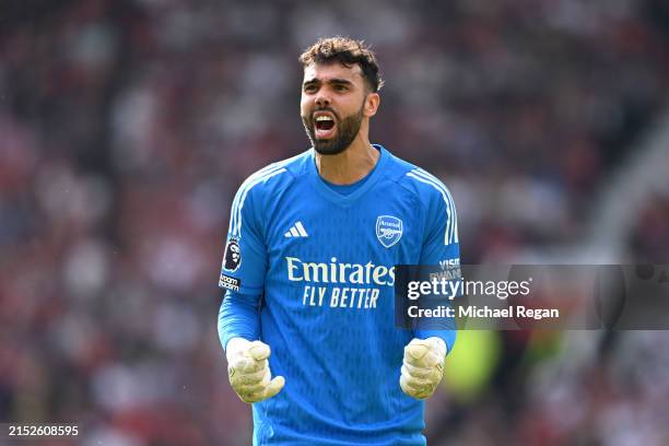 David Raya of Arsenal celebrates after Leandro Trossard scores his team's first goal during the Premier League match between Manchester United and...