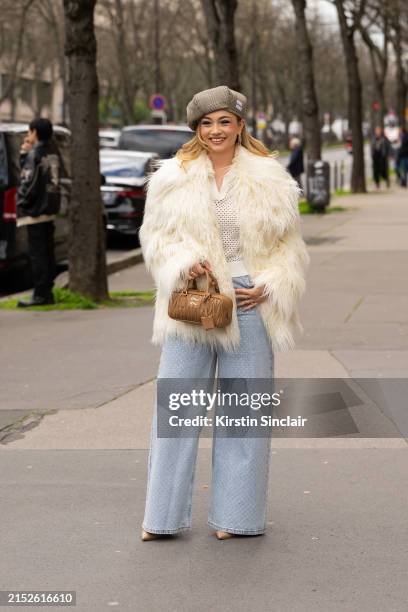 Merve Gorgotz wears The Frankie Shop jacket, Miu Miu hat and bag, Self Portrait jeans, Nude stiletto shoes and Sandro top outside the Miu Miu show...
