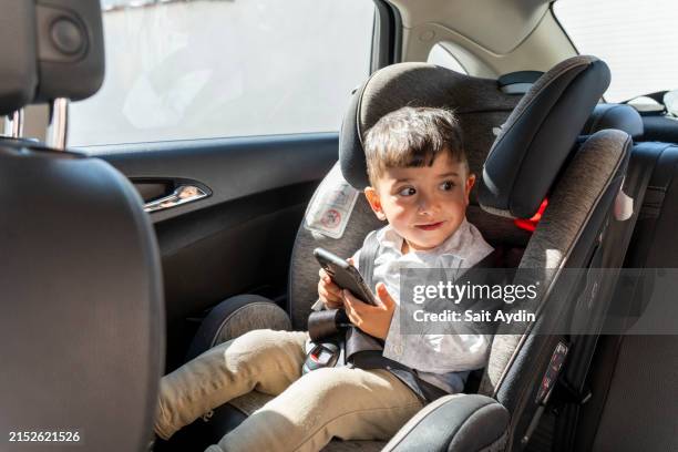 baby seat in car. cute boy on back seat of car. - back seat stock pictures, royalty-free photos & images