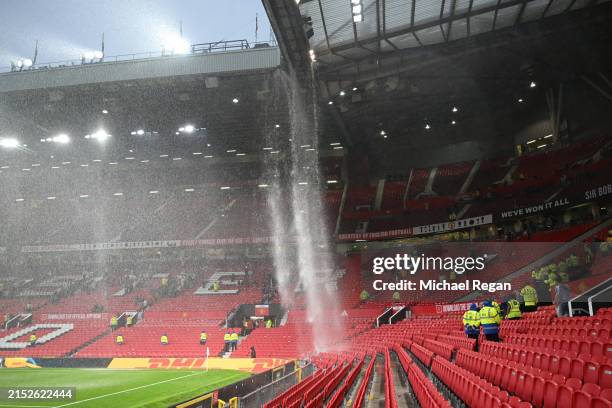 General view as the drainage pipe in the roofs of the Sir Alex Ferguson Stand and East Stand leaks and pours onto the seats below following heavy...