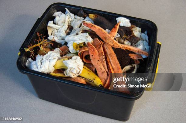 plastic crate household compost bin including vegetable peelings, used kitchen paper towel, banana skins, coffee grounds and other compostable waste - biodegradable stock pictures, royalty-free photos & images