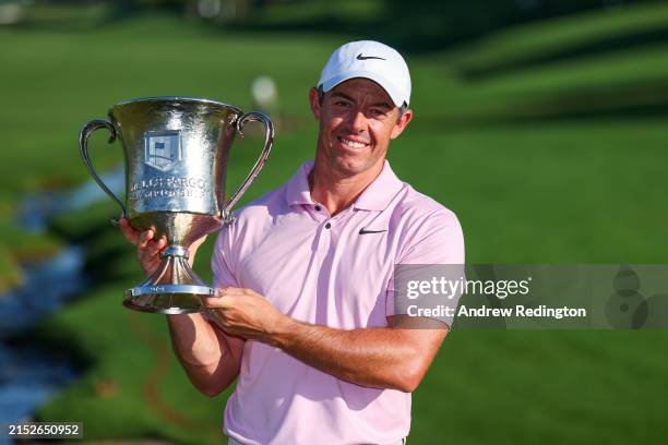 Rory McIlroy of Northern Ireland celebrates with the trophy after winning the Wells Fargo Championship at Quail Hollow Club on May 12, 2024 in...