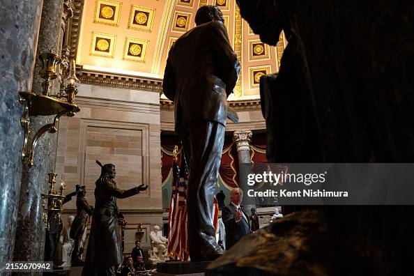 Rev. William Franklin Graham III gestures to the statue of his late