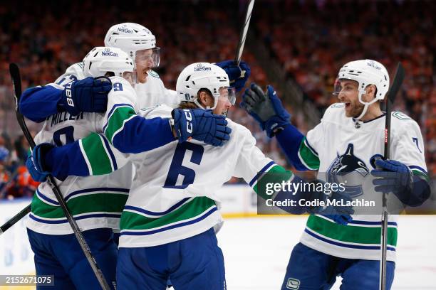 Brock Boeser of the Vancouver Canucks celebrates with teammates after a hat trick during the first period against the Edmonton Oilers in Game Three...