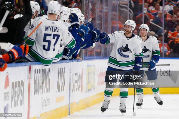 Elias Lindholm of the Vancouver Canucks celebrates with teammates after a goal during the second period against the Edmonton Oilers in Game Three of...