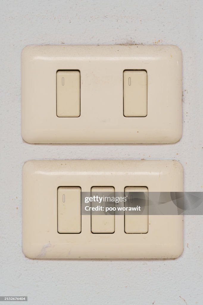 Light switch on a white wall.