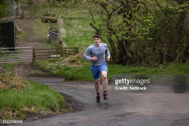 enjoying exercise outdoors - country road stock pictures, royalty-free photos & images
