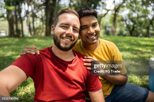 portrait of a gay couple on the public park - gay males stock pictures, royalty-free photos & images