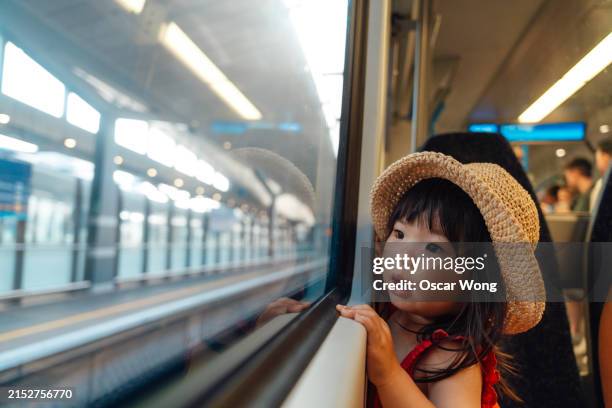 curious asian little girl looking out of the window on train - freedom stock pictures, royalty-free photos & images