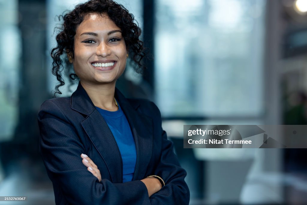 Support Women-led Businesses and Initiatives Can Boost Company Growth. Portrait of a Confident Business Executive Founder with arms crossed working in a modern business office.