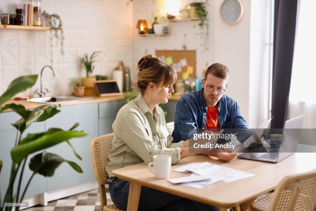 Man and woman paying bills from home