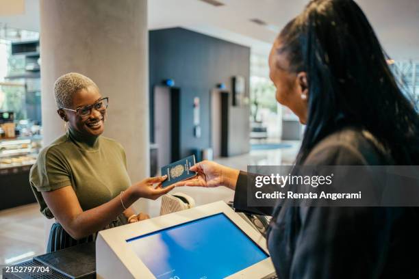 businesswoman making check in at hotel - travel check in stock pictures, royalty-free photos & images