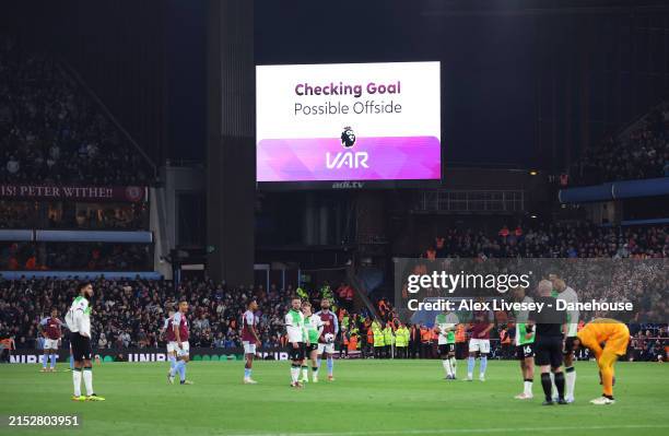 Checks and disallows a goal by Ollie Watkins of Aston Villa during the Premier League match between Aston Villa and Liverpool FC at Villa Park on May...