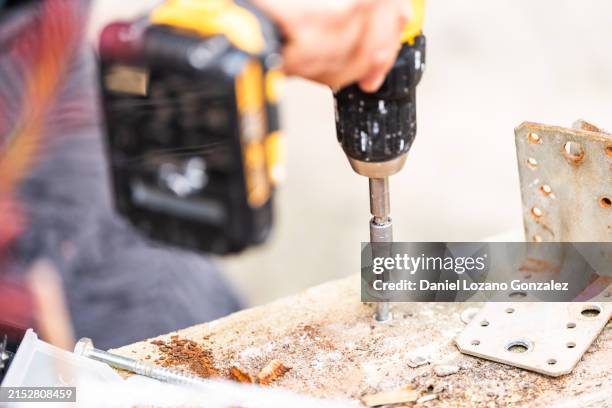 close-up of hand using electric screwdriver - drill stock pictures, royalty-free photos & images