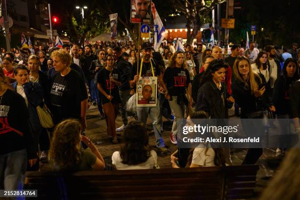 People sit around and watch as protesters march up Rothschild Blvd calling for a hostage and ceasefire deal on Yom Ha’atzmaut in Habima Square on May...