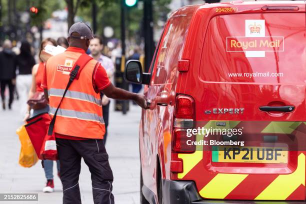 Postman removes letters and parcels from his Royal Mail vehicle in London, UK, on Friday, May 17, 2024. The owner of Britain's Royal Mail is inclined...