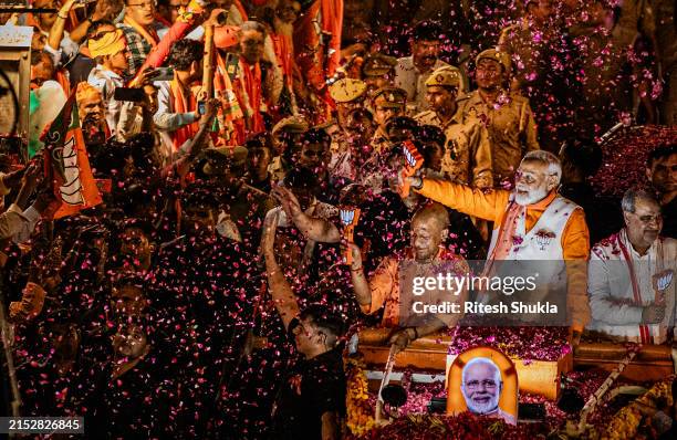 May 13: Indian Prime minister Narendra Modi waves to supporters during his roadshow on May 13, 2024 in Varanasi, India. Varanasi, in India's Hindu...