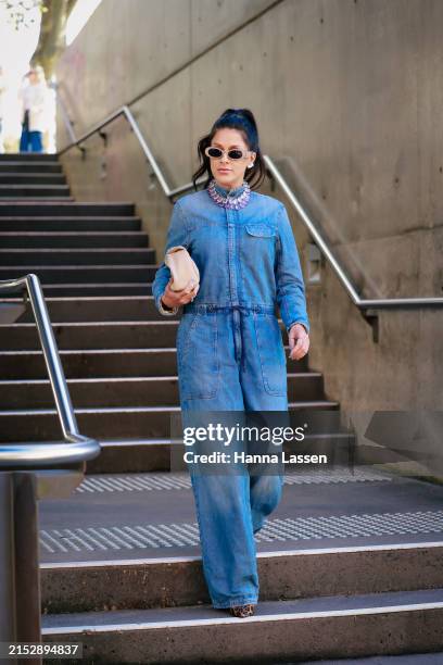 Guest wearing blue denim jumpsuit during Australian Fashion Week Presented By Pandora 2024 at Carriageworks on May 14, 2024 in Sydney, Australia.