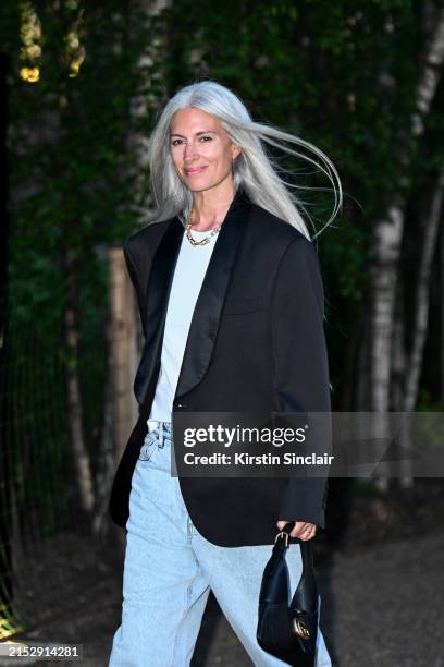 Sarah Harris wears a Black Tuxedo jacket, white T shirt, blue jeans and a Gucci bag outside the Gucci Cruise show 2025 at Tate Modern on May 13, 2024...