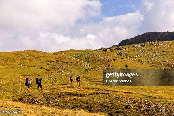 group of tourist climbing mountain slope on a summer trip - steep stock pictures, royalty-free photos & images