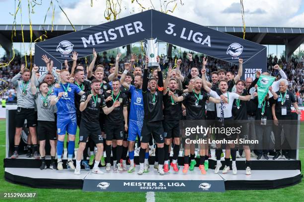 Ulm players celebrate with the trophy after finishing first in the 3. Liga after the match between SSV Ulm 1846 and SC Verl at Donaustadion on May...