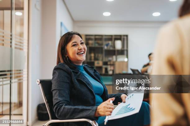 smiling businesswomen interacting - mannerism stock pictures, royalty-free photos & images