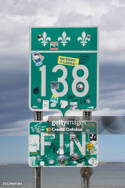 end of the 138 road sign, cote nord, quebec, canada - whale watching stock pictures, royalty-free photos & images