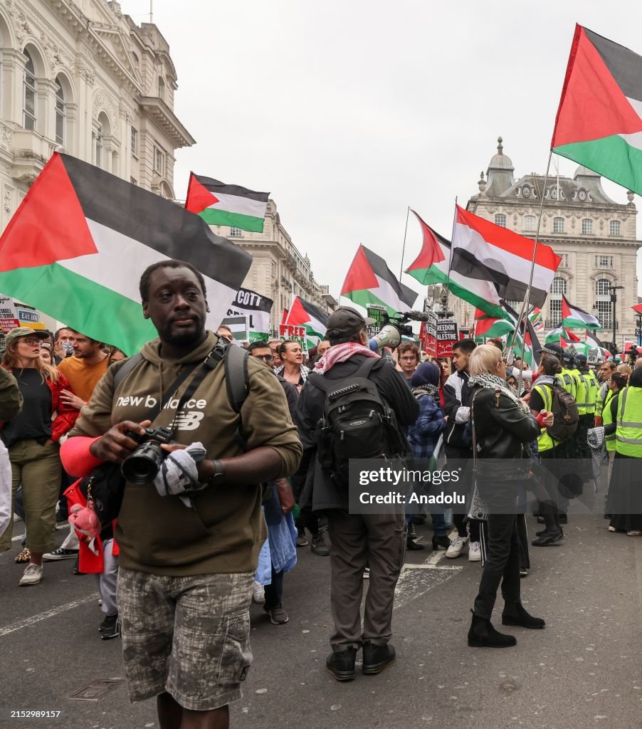 Pro Protesters Pro-Palestinian activists walk past the pro-Israel counter... News ...