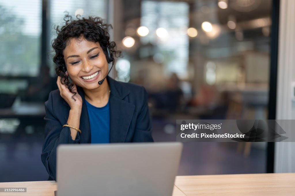 Customer service, happy and communication of woman at callcenter desktop talking with joyful smile. Consultant, advice and help desk girl speaking with clients online with computer headset mic.