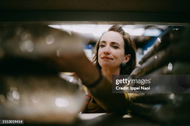 woman working in store restocking retail display - grocery store worker restocking shelves stock pictures, royalty-free photos & images