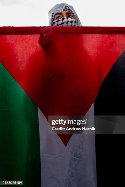Woman holds a Palestinian flag as pro-Palestinian activists hold a "Nakba 76" rally on the National Mall on May 18, 2024 in Washington, DC. Nakba...