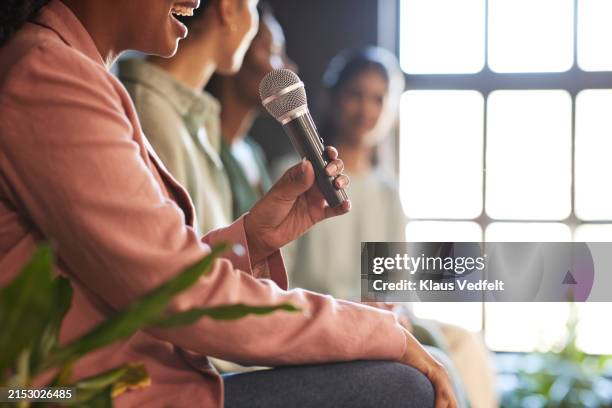 midsection of businesswoman explaining through microphone - panel discussion stock pictures, royalty-free photos & images
