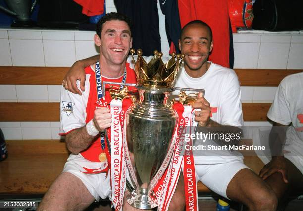 Martin Keown and Thierry Henry of Arsenal with the Premier League trophy after the match between Arsenal and Leicester City in the Premier League at...
