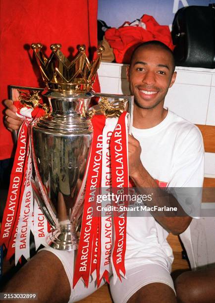 Thierry Henry of Arsenal with the Premier League trophy after the match between Arsenal and Leicester City in the Premier League at Highbury on May...