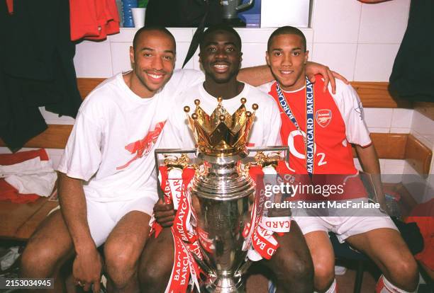 Thierry Henry, Kolo Toure and Gael Clichy of Arsenal with the Premier League trophy after the match between Arsenal and Leicester City in the Premier...