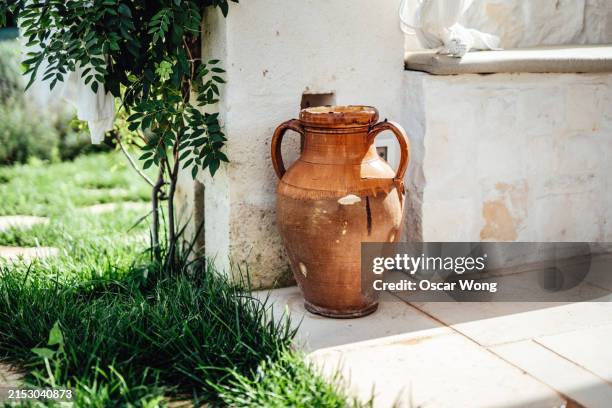 ancient clay jugs in the garden - earthenware stock pictures, royalty-free photos & images