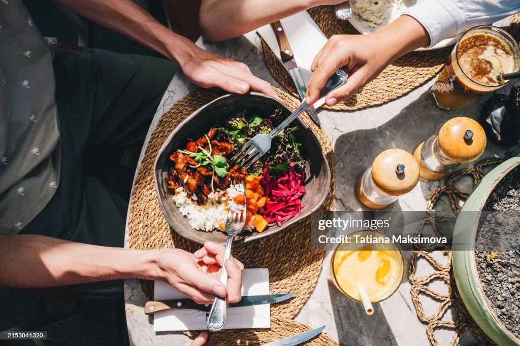 Bowl with healthy food. Fresh vegetables, beef and rice in a big plate. Sunny day, serving a meal in a cafe.