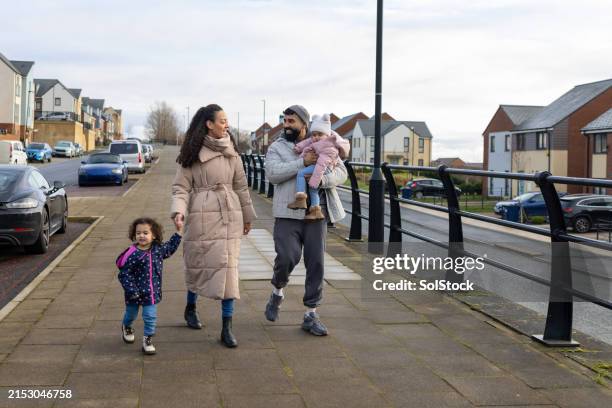 happy family strolling - couple crossing street stock pictures, royalty-free photos & images