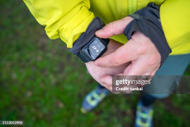 man checking sports activity values in tracker software on smartwatch - wearable computer stock pictures, royalty-free photos & images