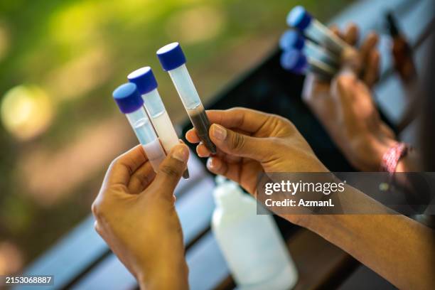 diverse scientists conducting ph test outdoors - medical sample stock pictures, royalty-free photos & images